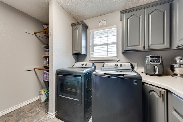 5709 E County Rd 97, Midland, TX 79706 - washroom with a textured ceiling, cabinet space, washing machine and dryer, and baseboards