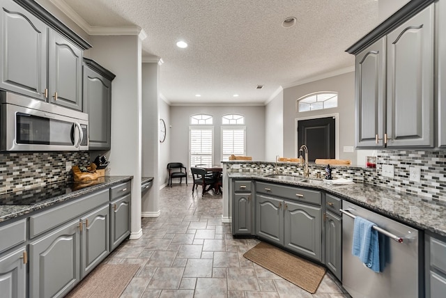 5709 E County Rd 97, Midland, TX 79706 - kitchen featuring gray cabinetry, stainless steel appliances, and a peninsula