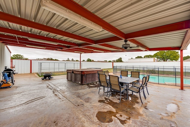 5709 E County Rd 97, Midland, TX 79706 - view of patio / terrace with a hot tub, fence, outdoor dining space, and a fenced in pool