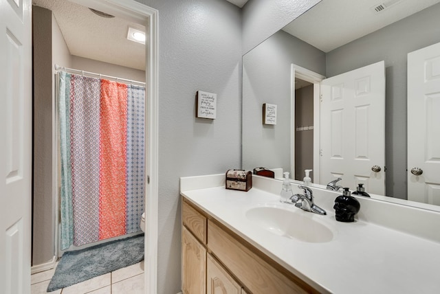 5709 E County Rd 97, Midland, TX 79706 - bathroom with tile patterned floors, toilet, vanity, a shower with curtain, and a textured ceiling