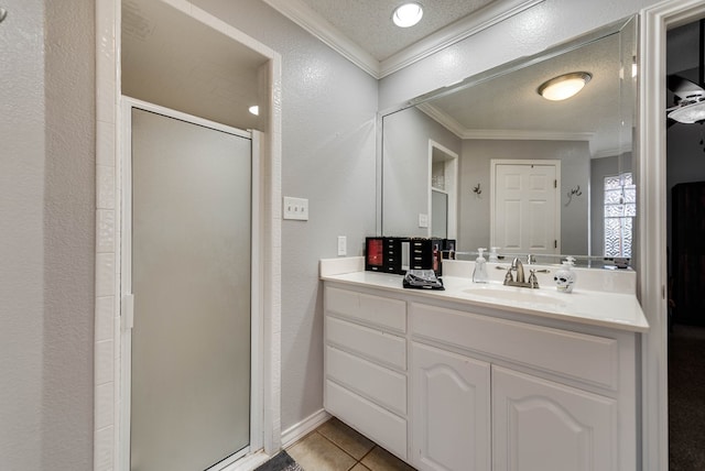 5709 E County Rd 97, Midland, TX 79706 - bathroom featuring crown molding, tile patterned floors, vanity, a stall shower, and a textured wall