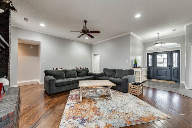 5709 E County Rd 97, Midland, TX 79706 - living area featuring hardwood / wood-style floors, baseboards, a textured ceiling, visible vents, and a ceiling fan