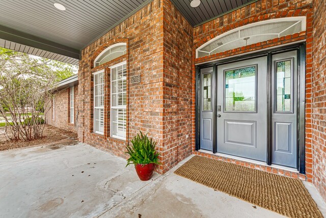 5709 E County Rd 97, Midland, TX 79706 - view of exterior entry featuring brick siding and a porch