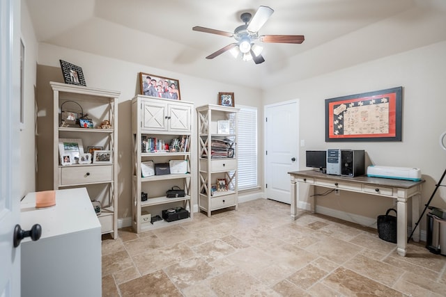 home office with baseboards, ceiling fan, and stone tile flooring