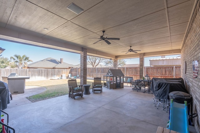 view of patio / terrace with a ceiling fan, a fenced backyard, and outdoor dining area