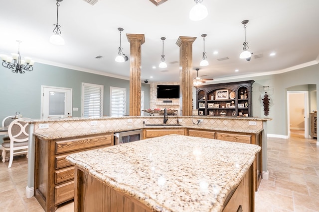 kitchen featuring a large island, wine cooler, ornamental molding, and a sink