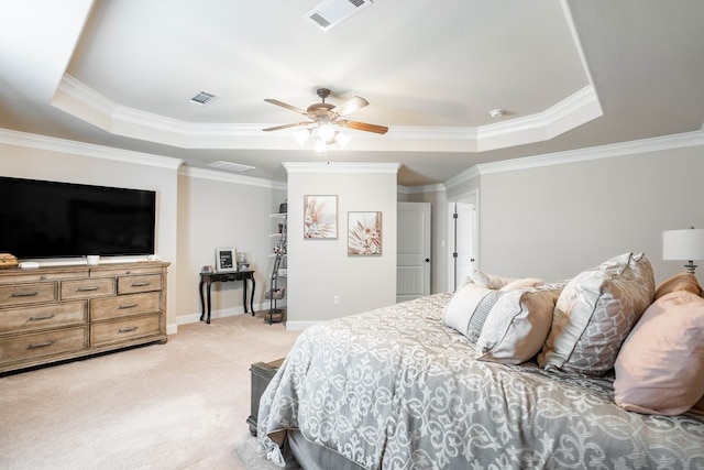 bedroom featuring a raised ceiling, visible vents, ornamental molding, and light carpet