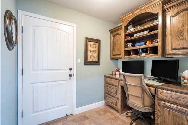 office area with baseboards and built in study area