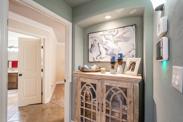 hallway with stone finish floor and baseboards
