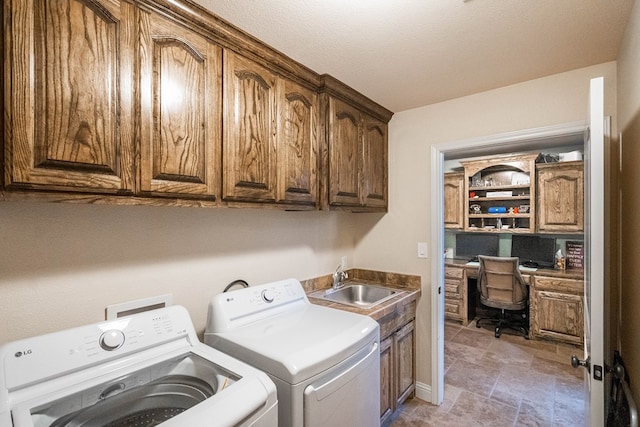 laundry area featuring a sink, cabinet space, and independent washer and dryer