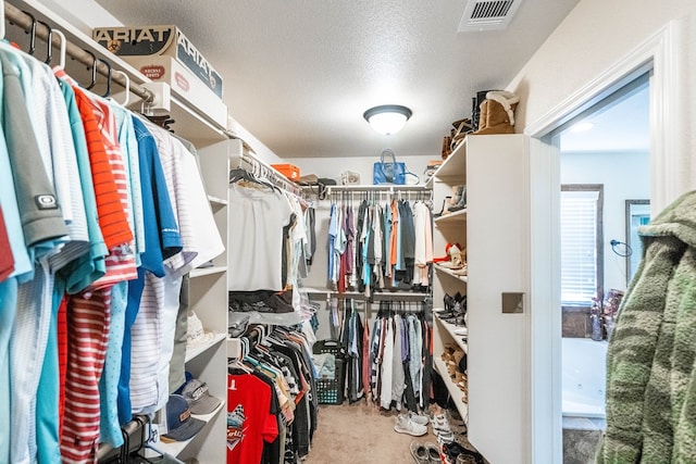 spacious closet with visible vents and carpet flooring