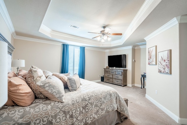 carpeted bedroom featuring baseboards, visible vents, a raised ceiling, and ornamental molding