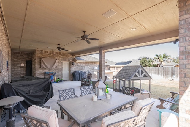 view of patio / terrace with outdoor dining area, ceiling fan, and a fenced backyard
