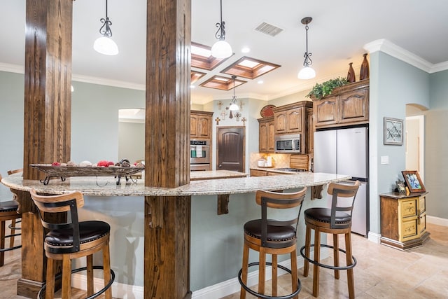 kitchen with visible vents, stainless steel appliances, a kitchen breakfast bar, and ornamental molding