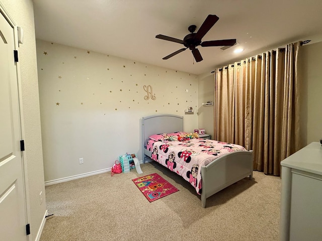 bedroom featuring light colored carpet and ceiling fan