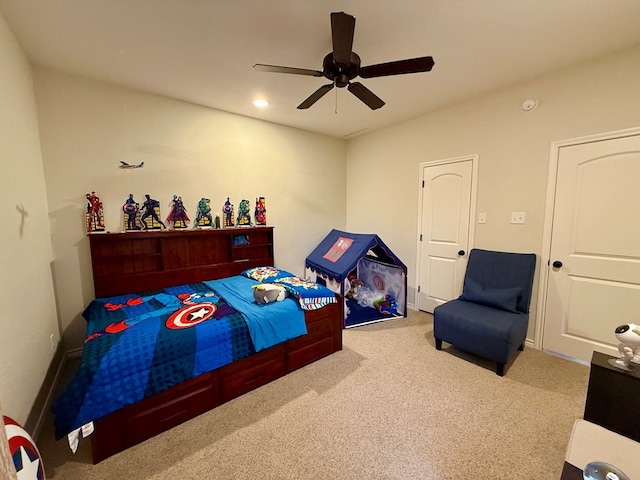 bedroom featuring light carpet and ceiling fan