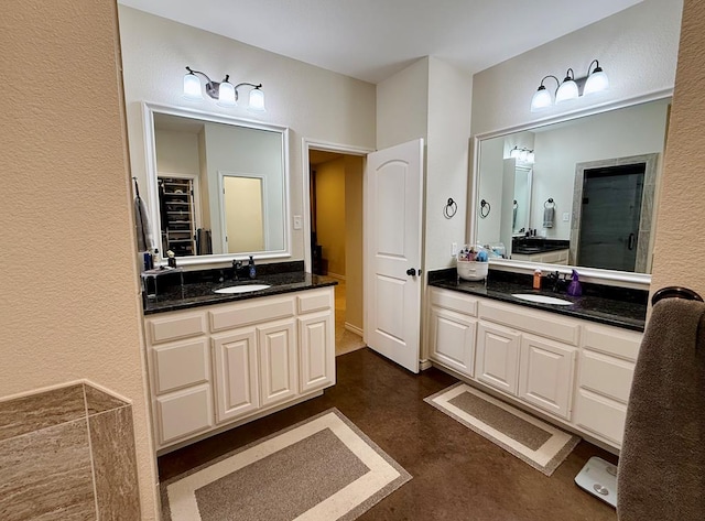 bathroom with walk in shower and vanity