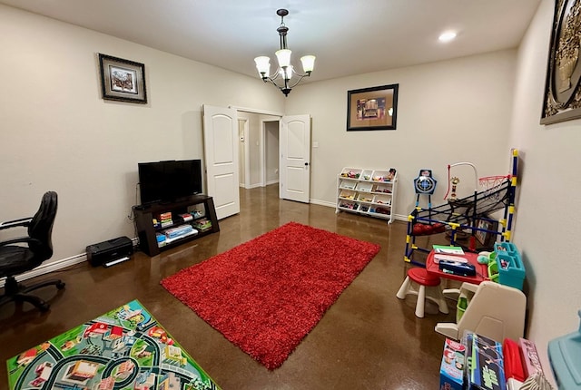 rec room featuring a notable chandelier