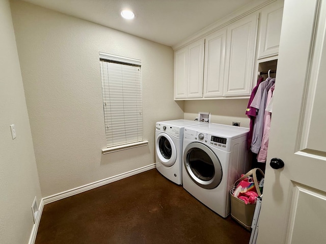 laundry area featuring cabinets and separate washer and dryer