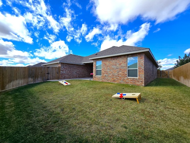 rear view of property with a lawn