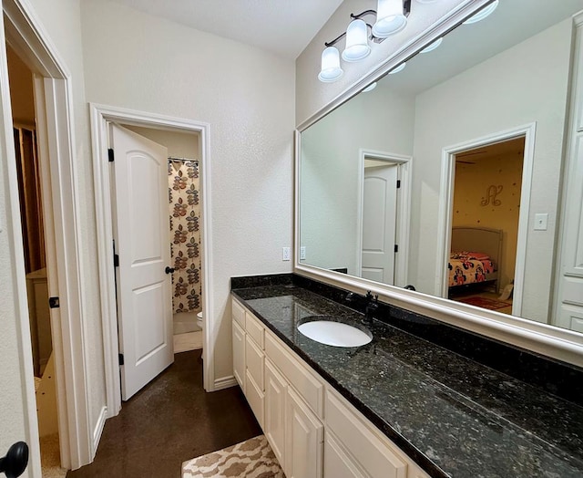 bathroom with vanity, curtained shower, and toilet