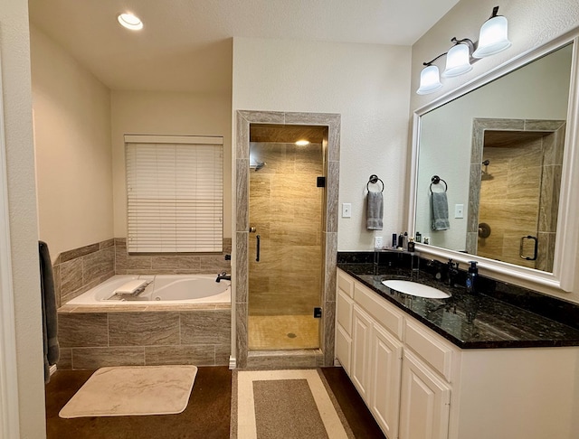 bathroom with tile patterned floors, vanity, and plus walk in shower