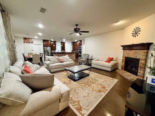 living room featuring a fireplace and ceiling fan