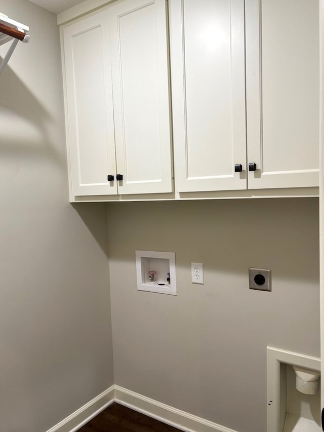 laundry area with hookup for an electric dryer, washer hookup, dark hardwood / wood-style floors, and cabinets