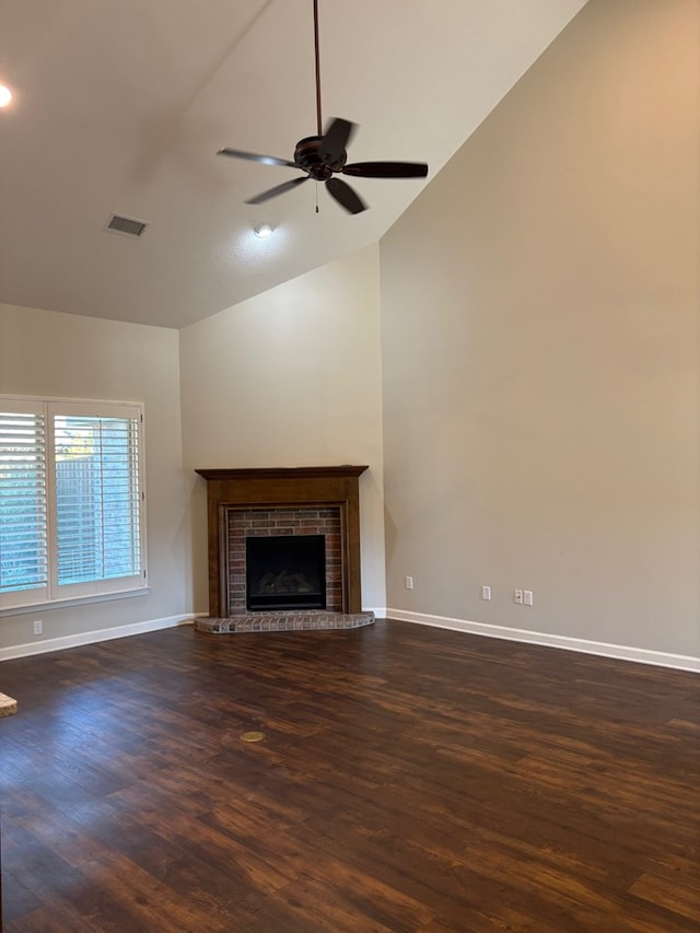 unfurnished living room featuring dark hardwood / wood-style flooring, ceiling fan, a fireplace, and vaulted ceiling