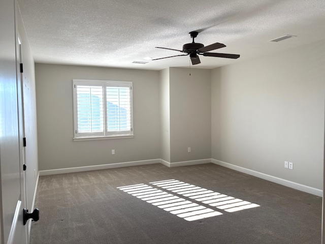 carpeted empty room featuring ceiling fan and a textured ceiling