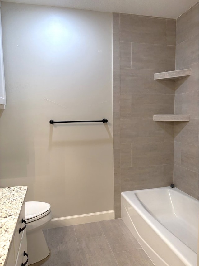 full bathroom with toilet, vanity, tile patterned floors, and tiled shower / bath combo