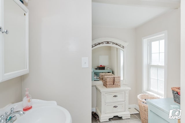 bathroom with tile patterned flooring and a sink