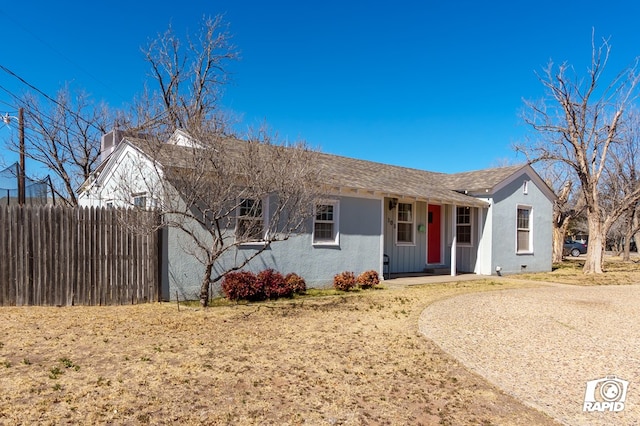 ranch-style house with fence and stucco siding