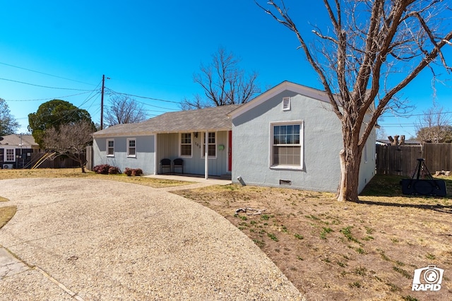 single story home with driveway and fence