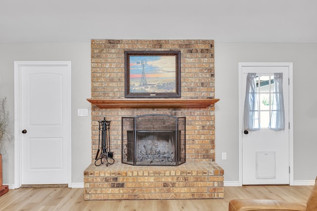 10606 E County Rd 104, Midland, TX 79706 - living area featuring wood finished floors and a brick fireplace