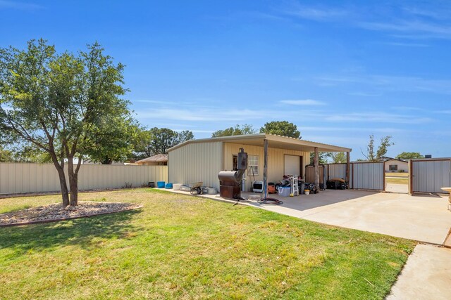 10606 E County Rd 104, Midland, TX 79706 - view of yard with concrete driveway, a garage, and an outdoor structure