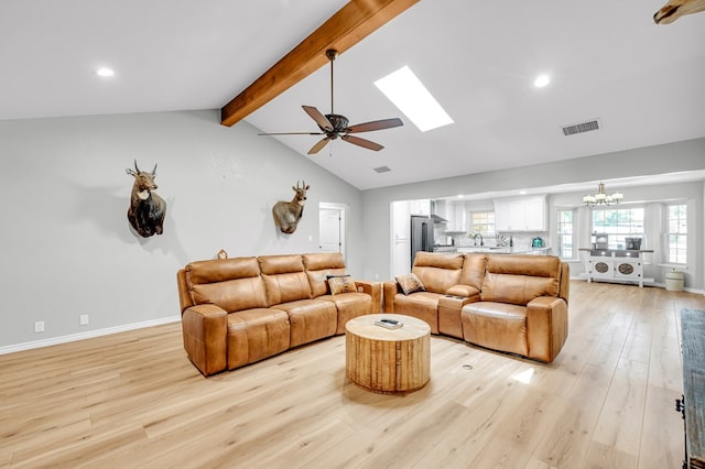10606 E County Rd 104, Midland, TX 79706 - living area with light wood-style floors, ceiling fan, recessed lighting, a chandelier, and a skylight