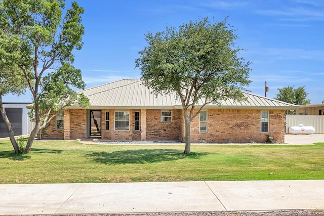 10606 E County Rd 104, Midland, TX 79706 - view of front of house with brick siding, a metal roof, and a standing seam roof