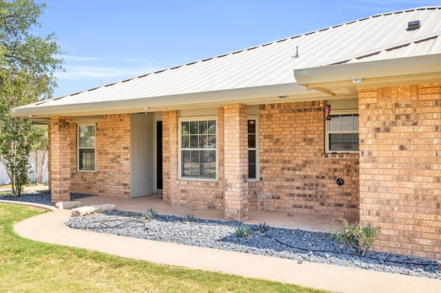 10606 E County Rd 104, Midland, TX 79706 - view of front of house featuring brick siding and a metal roof