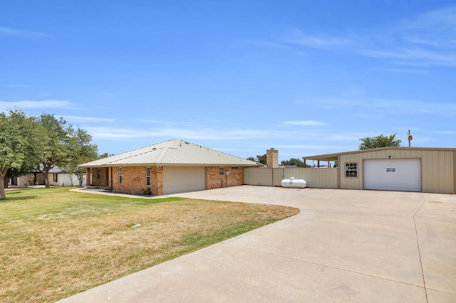 10606 E County Rd 104, Midland, TX 79706 - view of side of home featuring a detached garage and an outdoor structure