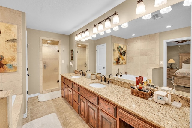10606 E County Rd 104, Midland, TX 79706 - ensuite bathroom featuring a stall shower, tile patterned floors, a garden tub, and double vanity