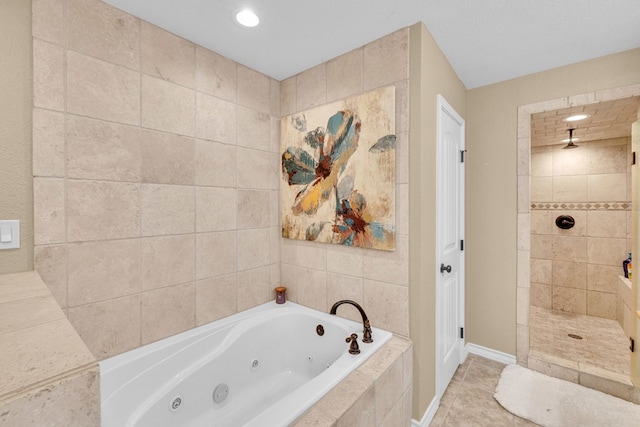 10606 E County Rd 104, Midland, TX 79706 - bathroom with a tub with jets, a walk in shower, tile patterned flooring, and recessed lighting