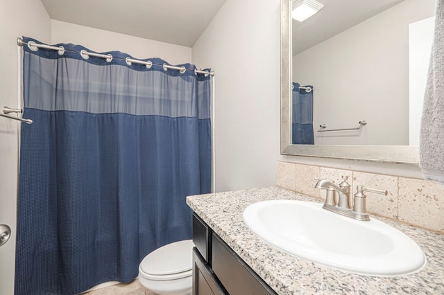 bathroom featuring vanity, toilet, and walk in shower