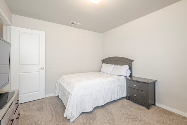 bedroom with light colored carpet