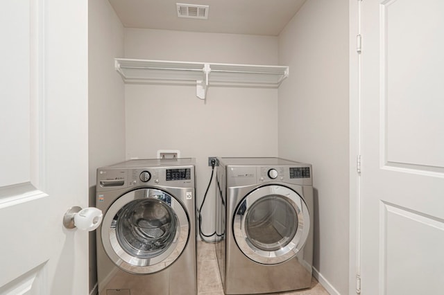 washroom with light tile patterned flooring and independent washer and dryer