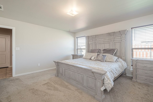 bedroom featuring light colored carpet