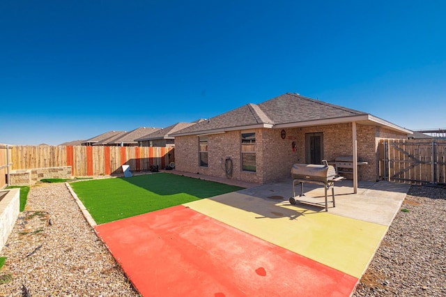 rear view of property with a lawn and a patio area