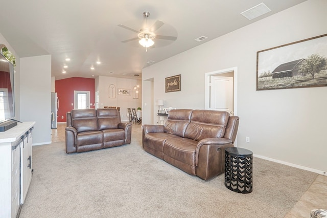 living room featuring ceiling fan, lofted ceiling, and light carpet