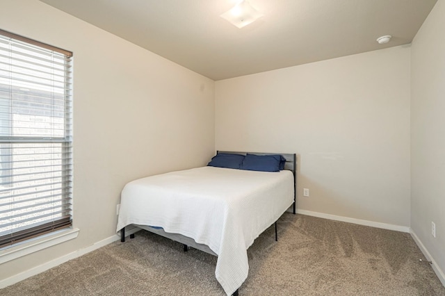 bedroom with multiple windows and carpet flooring