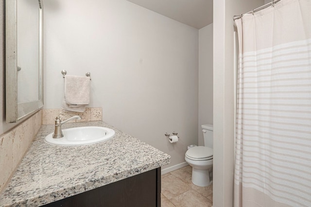 bathroom with vanity, tile patterned floors, and toilet